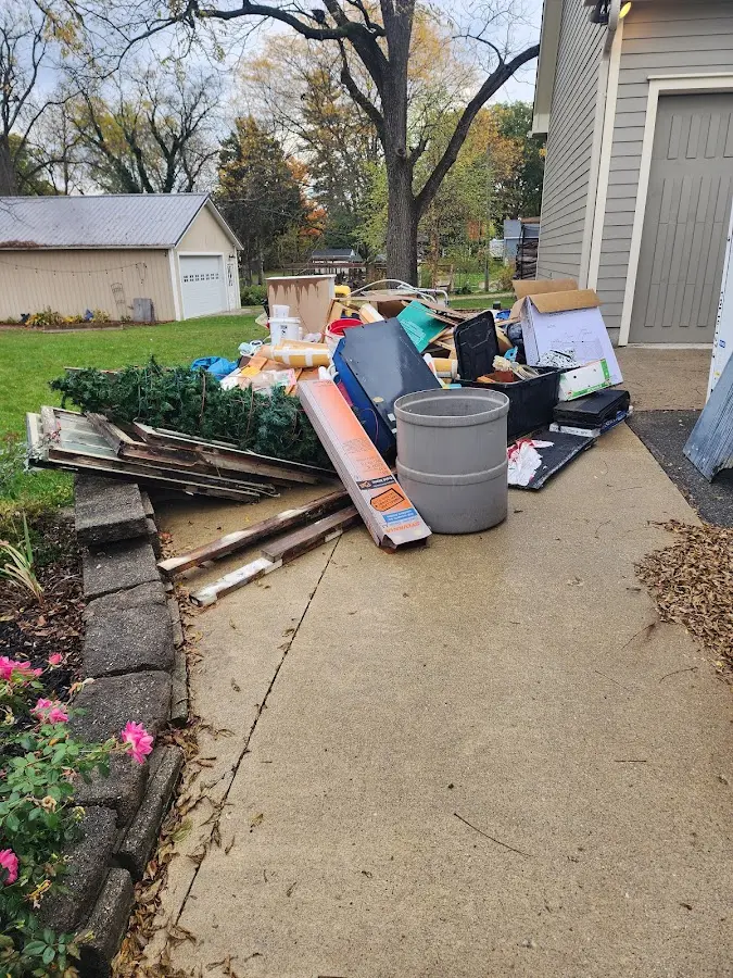 Dumpster being loaded with debris for 10 Yard Dumpster Rental in Colden
